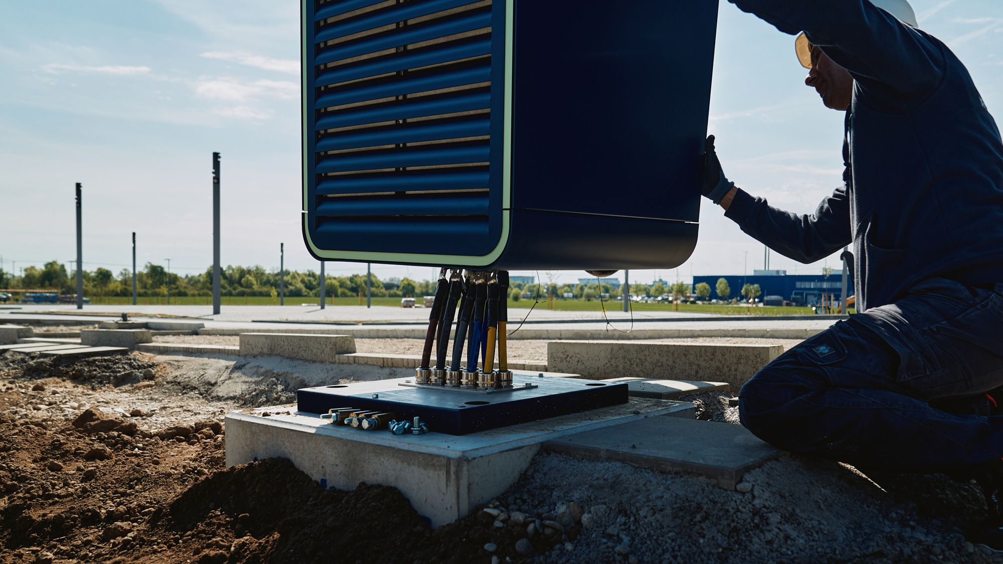 a man assembling a POWER Charger fast charging station