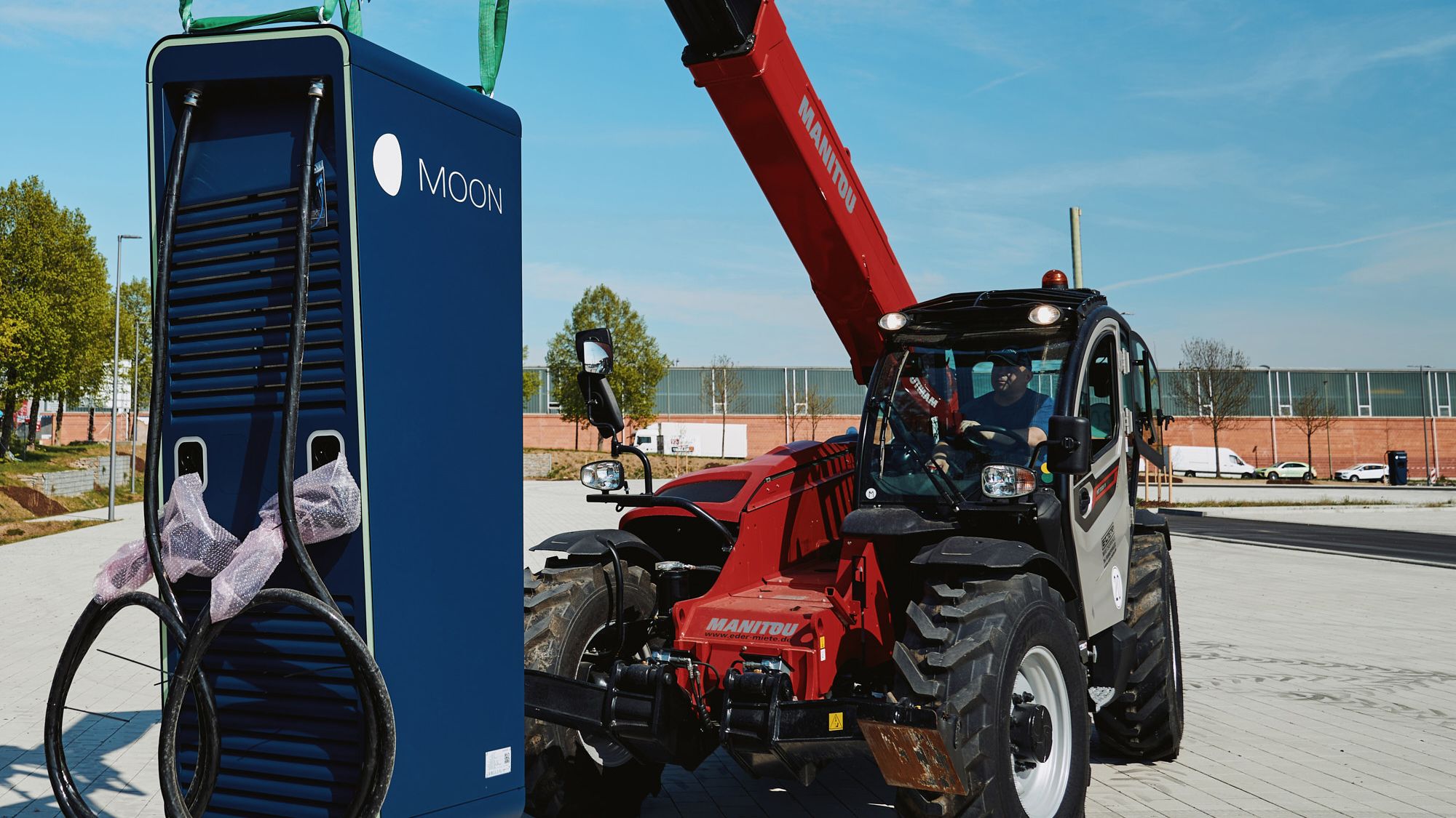 a man transports a POWER Charger fast charging station
