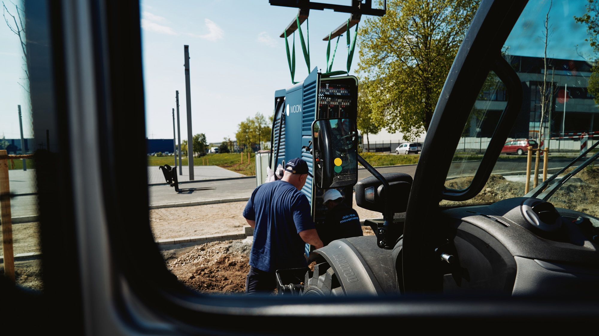 a man transports a POWER Charger fast charging station